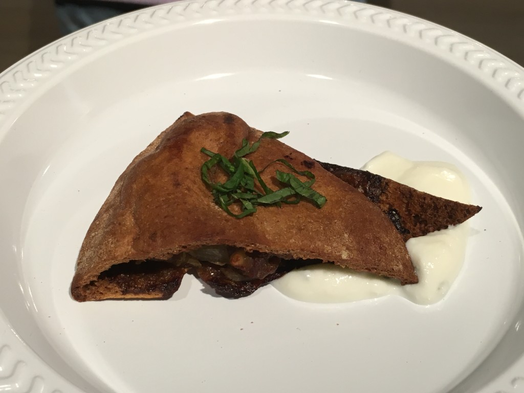 Arais with spiced beef filling in a whole wheat pita with yogurt sauce.